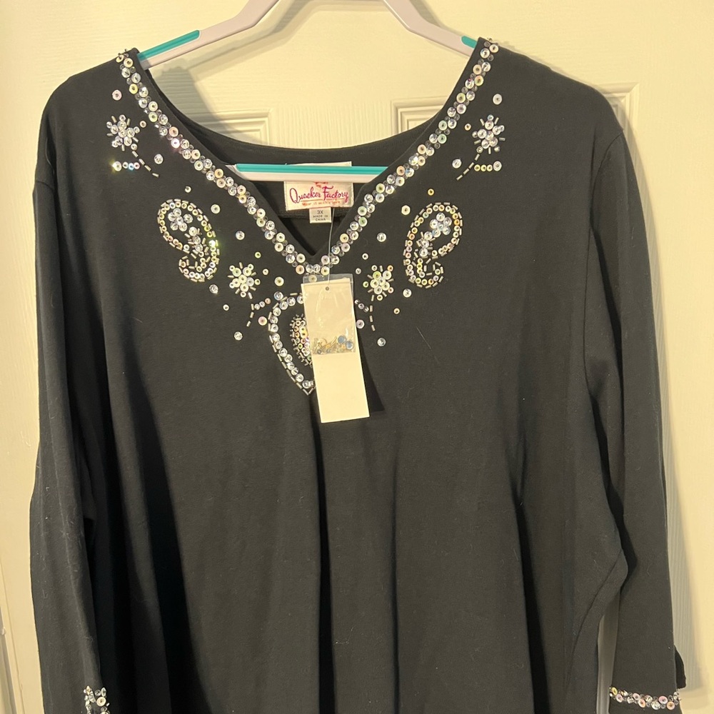 Women’s black light sweater with sequence.